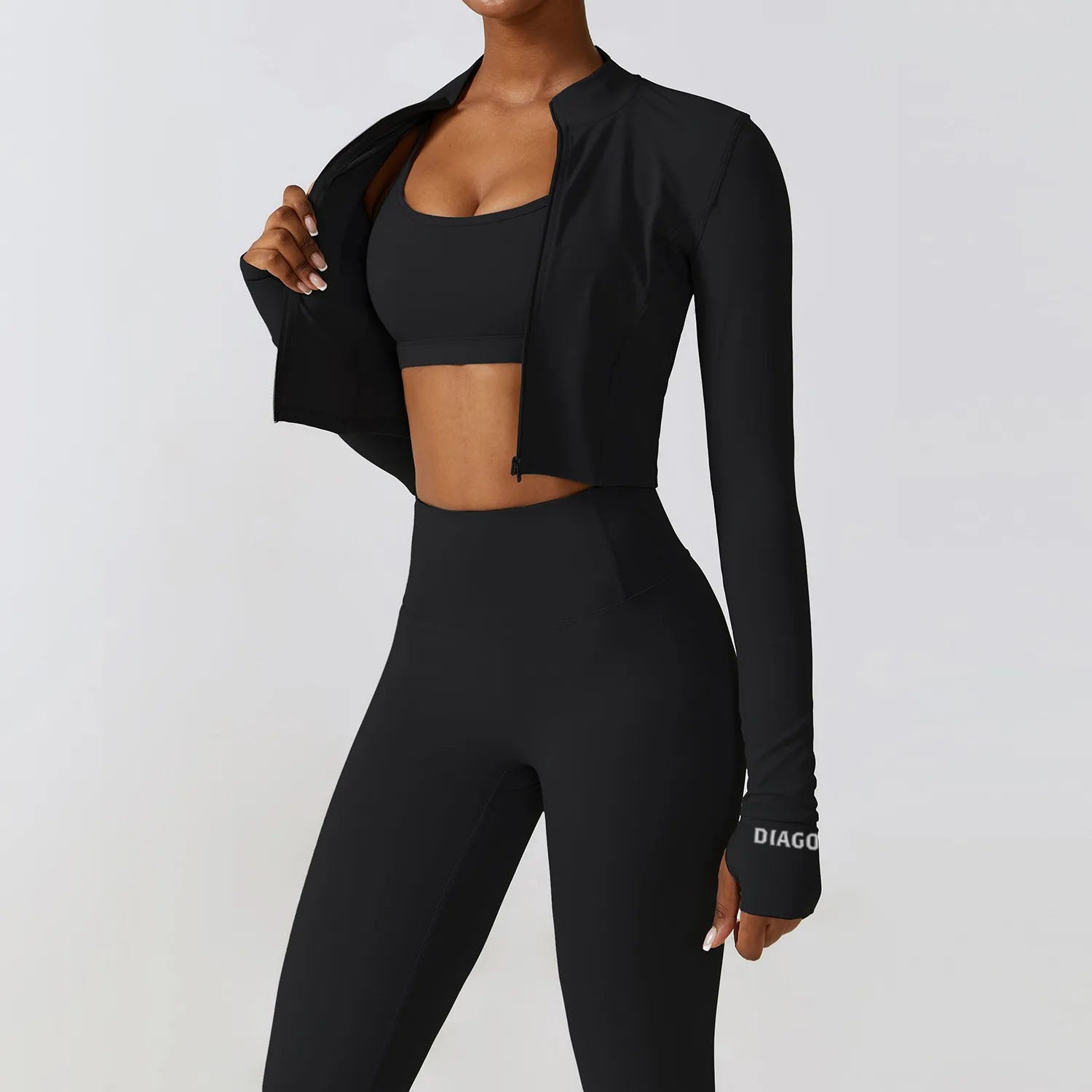 Model wearing Tempo 3-piece women’s training set in black, sports bra, leggings and zip top
